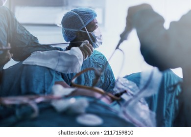 Setting The Standard For Surgical Excellence. Shot Of A Dedicated Team Of Young Surgeons Performing Surgery On A Patient In An Operating Room.