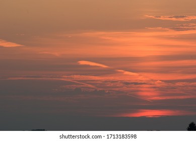 The setting sun in the evening sky.
