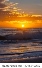 The setting sun getting low in the sky over the Pacific Ocean.
