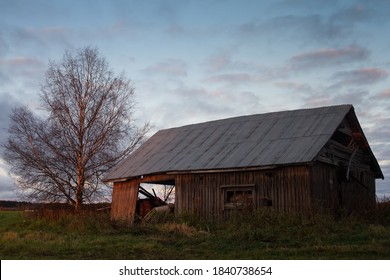 The setting sun lights up the old abandoned barn house. The autumn evenings are beautiful with very dramatic skies.