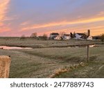 Setting sun over amish land in amish country