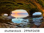The setting sun, reflected upon the chilly waters of Lake Superior, is viewed from a sea cave along the Upper Peninsula coast of northern Michigan.