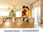 Setting table for family meal, young asian brother and sister arranging dishes in dining room. dinner, togetherness, home, preparation, lifestyle, relationship