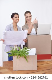 Setting Up Their New Office. Two Young Female Colleagues Moving Into Their New Office.