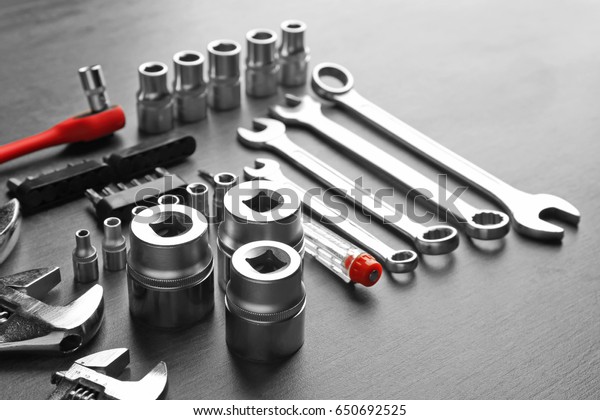 Setting of tools\
for car repair on grey\
table