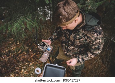 Setting up trail camera in forest