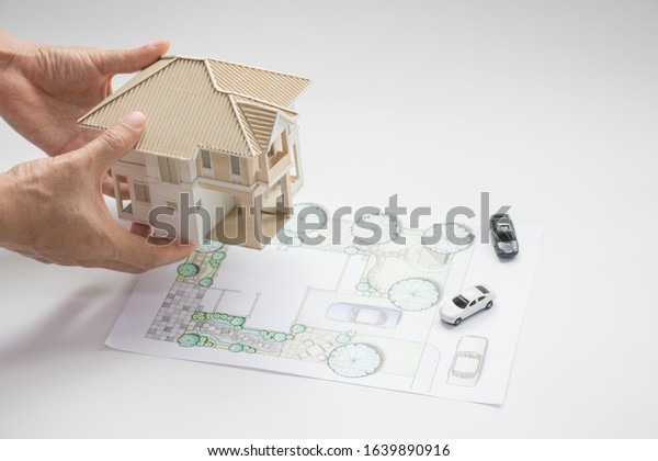 setting\
of two storey single house 3D mass model on layout plan of home\
landscape design or garden design or landscape architecture color\
drawing with car model by hand , selective\
focus