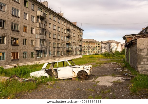 A settlement\
completely abandoned by people. Abandoned car in the yard.\
Zapolyarny, Vorkuta, Russia. 