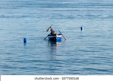 Setubal, Portugal - 17 December, 2020: fisherman checking his traps and catching octopus near Setubal on the Sado River Estuary