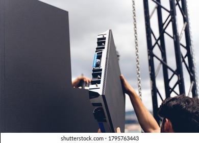 Setup phase a LED LCD wall or stage panel. Display system for concerts, with visible front panel with power and signal connectors visible.
