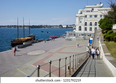 SEVASTOPOL, CRIMEA - JUN 10, 2018: People On Primorsky Boulevard Near Institute Of Marine Biology.