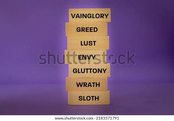 Seven Deadly Sins Listed on a Wooden\
Block, Violet Background, Concepts, Christian\
Faith