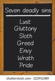 The Seven Deadly Sins Written On A Blackboard