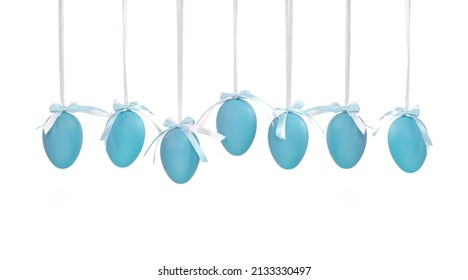 Seven Easter blue eggs hanging on ribbons isolated on a white background. Solid colour Easter eggs. 