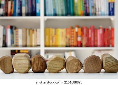 Seven Empty Wooden Blocks In Front Of Home Library. Blank Wood Blocks Mockup And Blurred Bookshelf.