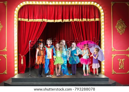 Seven happy children in costumes on red stage in theater, collage