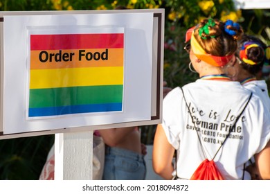 Seven Mile Beach, Grand Cayman, Cayman Islands - July 31st 2021: A Young Person Waits In Line For Food As The Cayman Islands Hosts Its First Ever Gay Pride Celebration