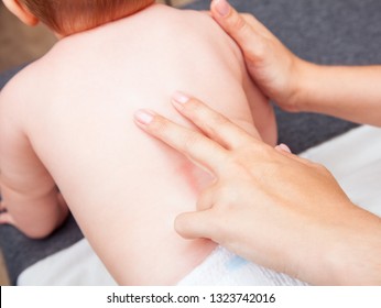 Seven Month Baby Girls Spine Being Manipulated By Osteopathic Or Chiropractic Manual Therapist In A Pediatric Clinic