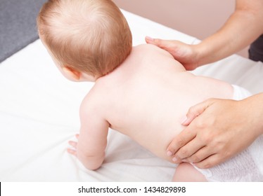 Seven Month Baby Girls Spine Being Manipulated By Osteopathic Or Chiropractic Manual Therapist In A Pediatric Clinic