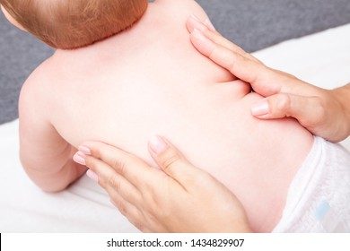 Seven Month Baby Girls Spine Being Manipulated By Osteopathic Or Chiropractic Manual Therapist In A Pediatric Clinic