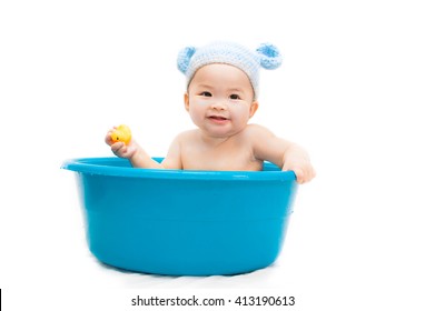 Seven Month Old Asian Baby In Bathtub And She Play Yellow Duck On White Background