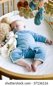 Seven Month Old Baby Boy Sound Asleep In His Crib