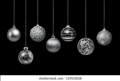 Seven silver decoration Christmas balls collection hanging, black background isolated