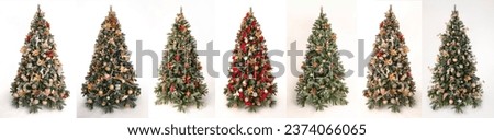 Seven very beautiful decorated christmas trees side by side in front of a white background