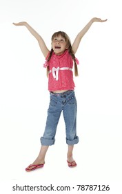 Seven Year Old Girl Standing On White Background Looking Upward With Arms Extended Upward.