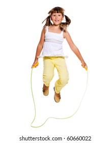 Seven years Girl jumping with skipping rope isolated on white