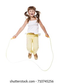 Seven years Girl jumping with skipping rope isolated on white