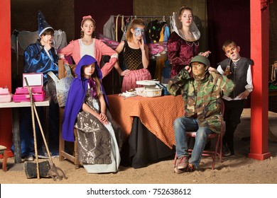 Seven young theater students prepare in the dressing room wearing their costumes