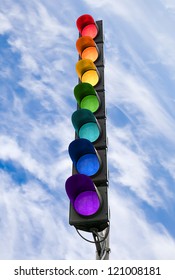 Seven-color rainbow scheme traffic light concept above blue sky