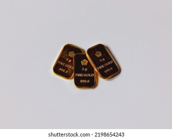 Several 5 Gram Gold Bars On A White Background.