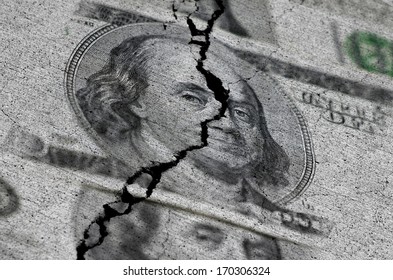 Several American Dollars ripped or torn in half symbolizing the destruction of the economy