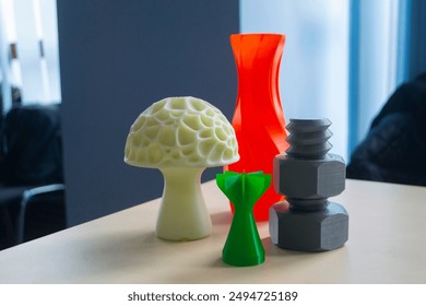 Several art multi-colored objects printed on a 3D printer. Model red vase, white mushroom, green tip, gray washer and bolt created 3D printer from molten plastic. Additive progressive technology - Powered by Shutterstock