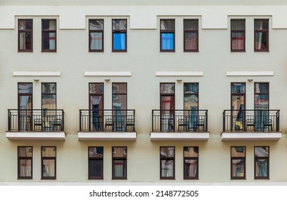 Several balconies and many windows in a row on the facade of the modern urban apartment building front view, Krasnaya Polyana, Sochi, Krasnodar Krai, Russia