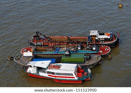 Several barges moored at Thames River