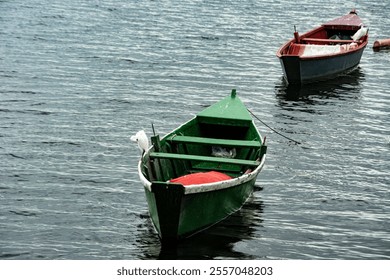 Several boats anchored in a peaceful bay with calm waters, surrounded by scenic hills and clear skies. The image captures tranquility and nature's beauty. - Powered by Shutterstock