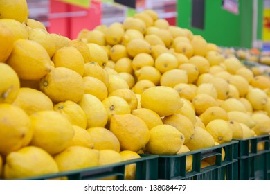Several boxes full with lemons in the store.