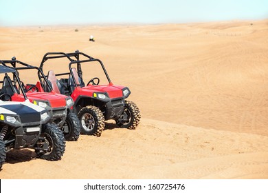 Several buggies in the desert.