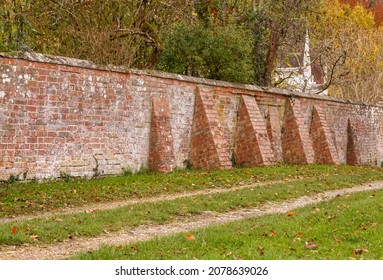 several buttress piers supporting a red brick wall of an English Country House in Fittleton, Wiltshire UK - Shutterstock ID 2078639026