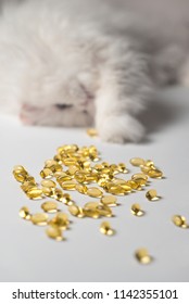 Several Capsules Of Fish Oil. Curious Cat In The Background. White And Yellow Colors