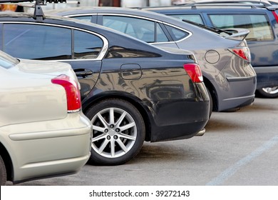 Several Cars Parked In A Parking Lot