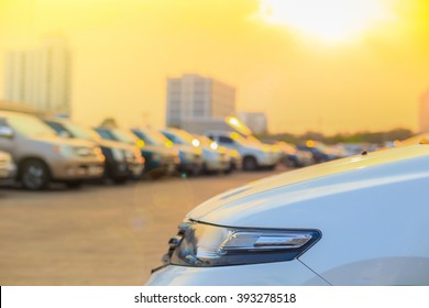 Several Cars Parked In A Parking Lot Against Sun Rise