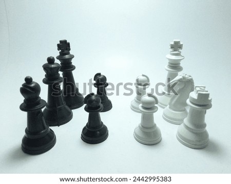 several chess pieces facing each other on white background
