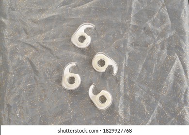 Several Clear Plastic Wrapping Tape Single Use Disposable Roll Dispenser Containers On A Home Dining Room Tabletop Seen From Directly Above Flat Lay