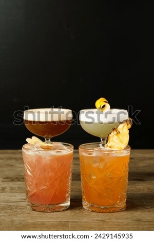 Several cocktails next to each other on a wooden table