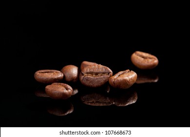 Several coffee beans isolated on black background with reflection. Culinary coffee background. - Powered by Shutterstock