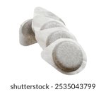 Several coffee pods for espresso machine forming ascending line are lying on white background